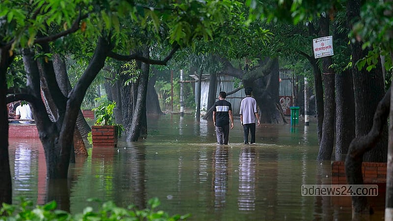 Due to waterlogging around Dhanmondi Lake, the walking paths have been submerged. Surroundings are inundated. Photo: Mahmud Zaman Ovi