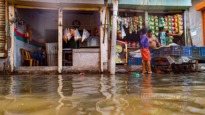 The partially submerged shops at Matuail Uttorpara in Dhaka’s Jatrabari continue sales after overnight rain triggered by Cyclone Remal. Photo: Mahmud Zaman Ovi