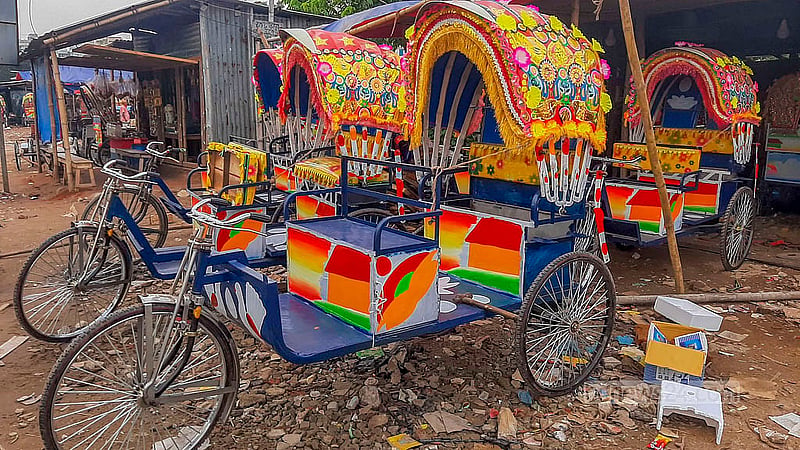 Several battery-run rickshaws await delivery at a workshop in Dhaka’s Rayerbazar.
