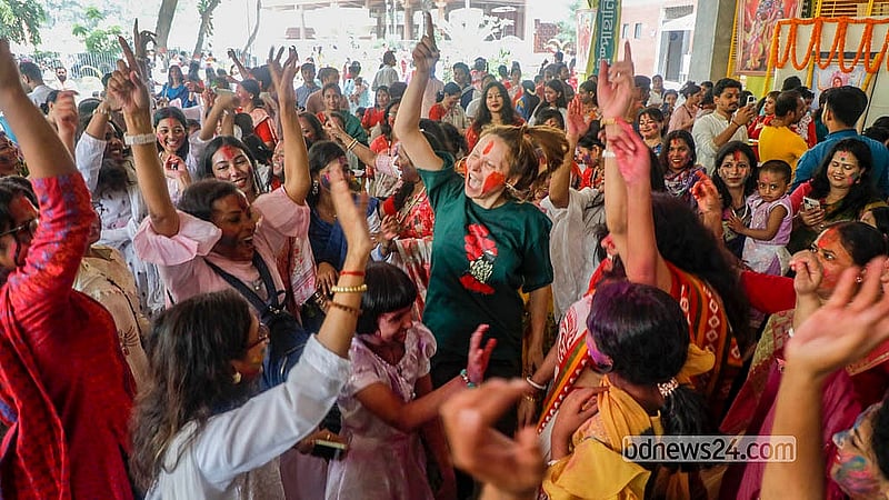 Devotees, covered in powdered colours, dance and sing during the Doljatra at Dhakeshwari Temple on Tuesday, Mar 3, 2026. Photo: Abdullah Al Momin