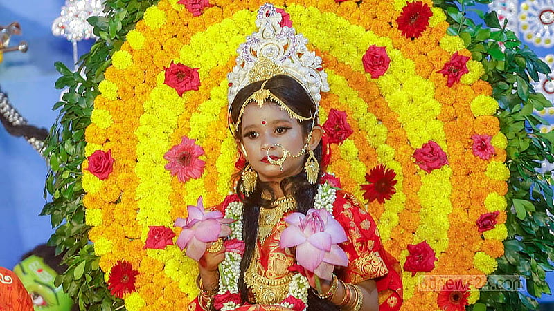 A child is seen worshipped in the form of a Kumari sitting on the throne of the goddess at the Ramakrishna Mission in Dhaka on Tuesday, the eighth day of Durga Puja. Photo: Abdullah Al Momin
