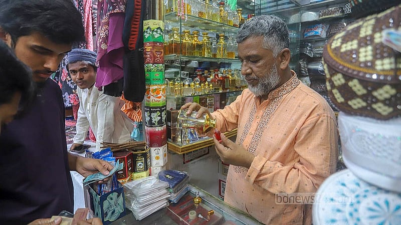 A shopper buys attar from a shop in front of the Baitul Mukarram Mosque ahead of Eid ul-Fitr. Photo: Abdullah al Momin