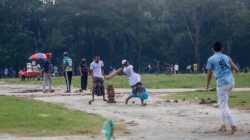 Though the research field of Sher-e-Bangla Agricultural University remains empty, a signboard on one side reads “Access Restricted”. Yet, children and teenagers gather there to play and exercise every afternoon. Photo: Mahmud Zaman Ovi