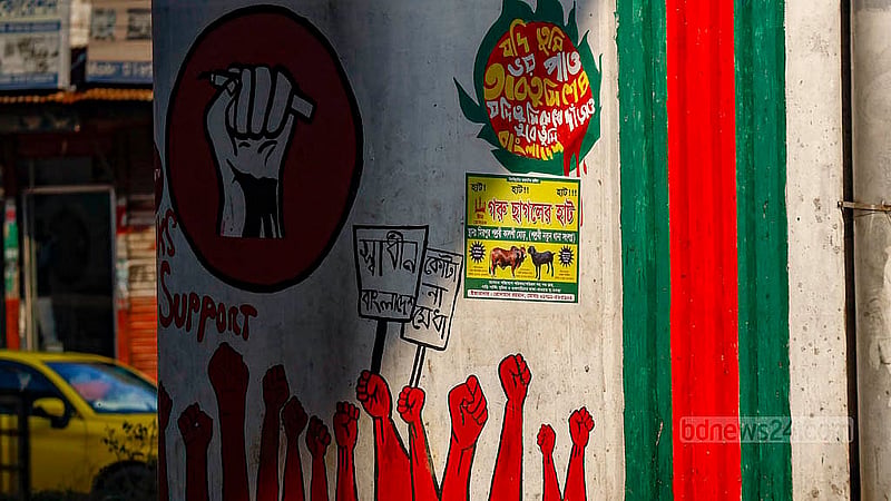 Graffiti commemorating the July Uprising once stood out on a pillar of the flyover at the Kalshi intersection in Dhaka. Now, within a year, they have been obscured b posters.. Photo: Mahmud Zaman Ovi