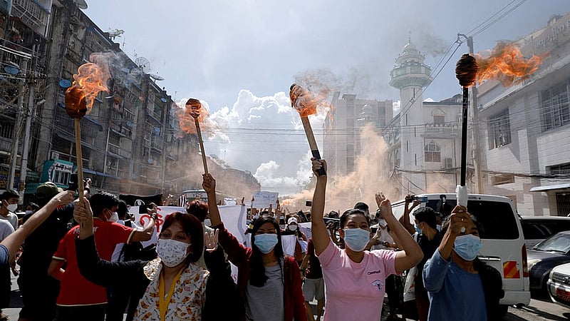 FILE PHOTO: A group of women hold torches as they protest against the military coup in Yangon, Myanmar July 14, 2021. REUTERS