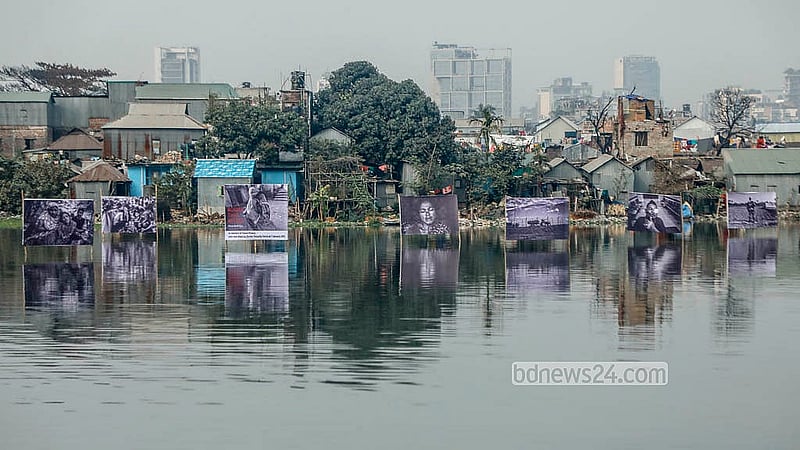 Seven photographs by Parvez Ahmed Rony displayed on a floating installation in the lake, with the Korail slums in the background, marking Felani Day and protesting border killings. Photo: Abdullah Al Momin