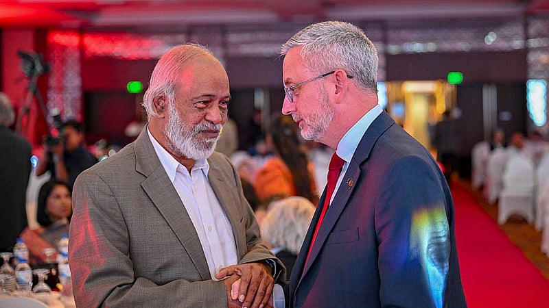 European Union Ambassador Charles Whiteley shares a light moment with BNP Standing Committee member Abdul Moyeen Khan during the 19th anniversary celebration of bdnews24.com at the Radisson Blu Water Garden Hotel in Dhaka on Thursday, Oct 23, 2025.