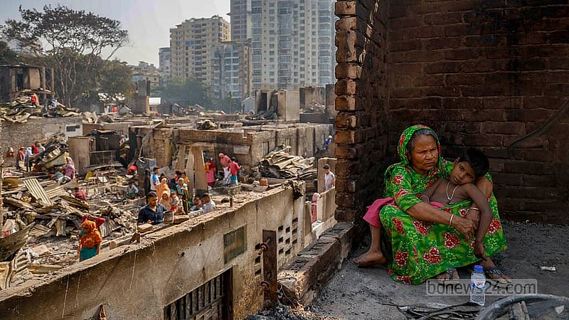 Joynab Begum sits under the open sky with her granddaughter Jonaki, a child with disability, in her lap. She had lived in her son’s small home, now completely destroyed. Photo: Mahmud Zaman Ovi