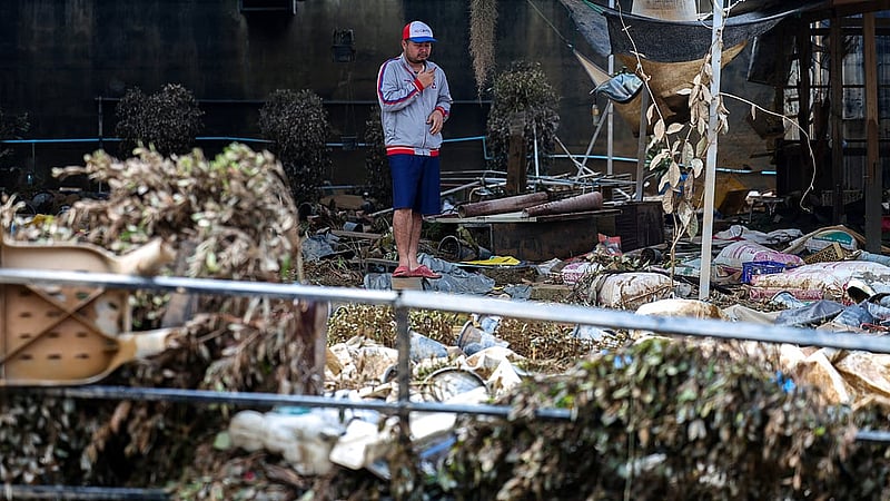 A man stands amid debris in a flooded area in Hat Yai district, Songkhla province, Thailand, Nov 28, 2025. REUTERS/Athit Perawongmetha