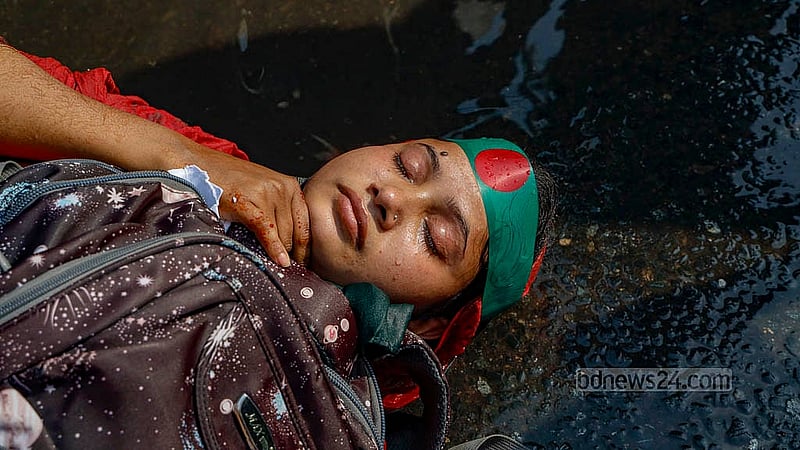 A protesting woman is seen lying on the street after police used water canons to disperse protesters demanding the reinstatement of cancelled appointment for primary school assistant teacher during a sit-in demonstration at Shahbagh Intersection on Thursday, Feb 13, 2025. Photo: Mahmud Zaman Ovi