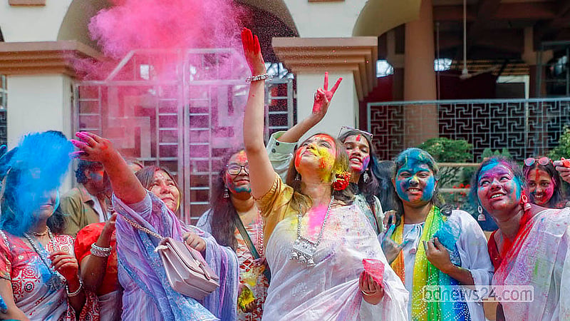 Young people, covered in powdered colours, dance during the Doljatra at Dhakeshwari Temple on Tuesday, Mar 3, 2026. Photo: Abdullah Al Momin