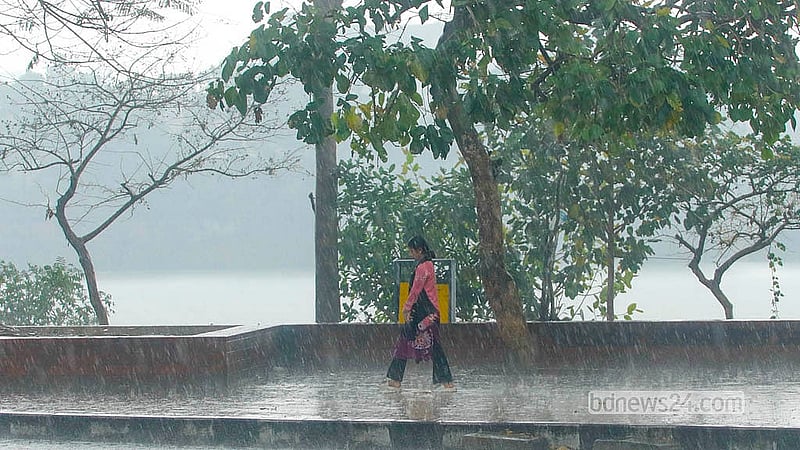 A woman walks through the rain in Dhaka’s Hatirjheel on Monday, Mar 2, 2026. Photo: Abdullah Al Momin