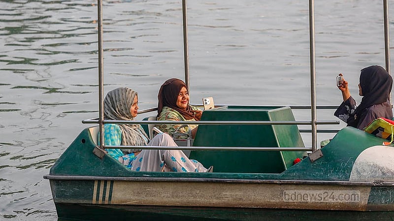 Young women steer their paddle-boat across the waters of the Merul section of Hatirjheel. Photo: Mahmud Zaman Ovi