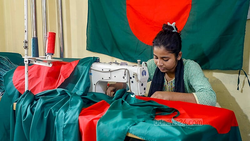 A woman sews national flags at a workshop in Dhaka’s Kadamtali area.Photo: Abdullah Al Momin
