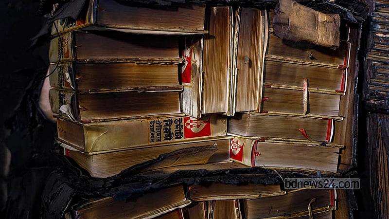A variety of books burnt in the attack and arson on the second floor of the central office of Udichi Shilpigosthi are stacked for display on Tuesday, Jan 13, 2026. Photo: Mahmud Zaman Ovi