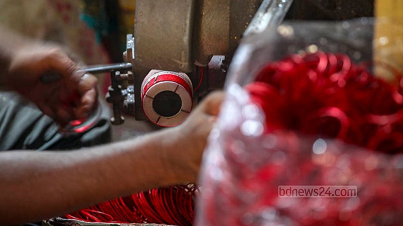These silver bangles are laced together before they are wrapped up. Depending on the design and colour, a handful of bangles are sold at wholesale for Tk 8-20 in Dhaka’s Lalbagh. Photo: Abdullah Al Momin