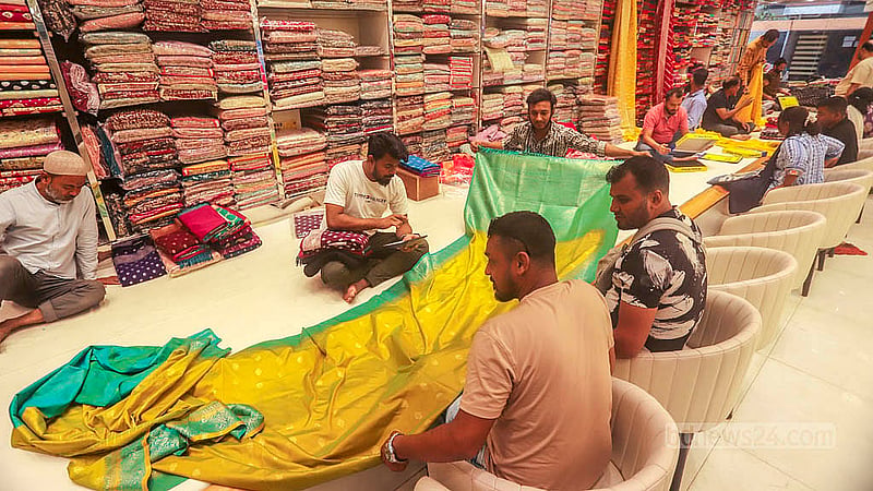 Customers crowd a store at Benarasi Palli in Dhaka’s Mirpur. The buyers browse the selections and haggle before making their purchases for Eid. Photo: Abdullah al Momin