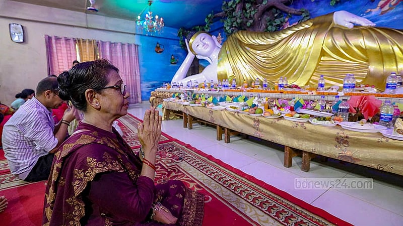 A devotee prays in front of a statue of Lord Buddha in Dhaka on their largest festival Buddha Purnima on Wednesday, May 22, 2024. Photo: Mahmud Zaman Ovi