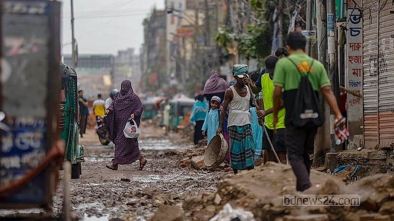 Potholes filled with water and mud block the road to Jatrabari intersection. Locals of South Jatrabari are forced to wade through it to get around. Photo: Mahmud Zaman Ovi