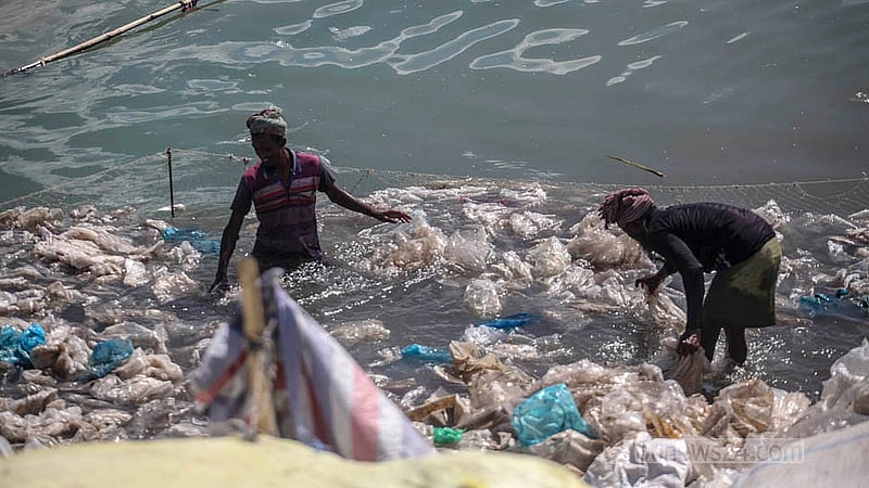 Workers clean polythene in the Buriganga River at Islambagh in Old Dhaka, where waste from different regions is brought for processing. Photo: Abdullah Al Momin