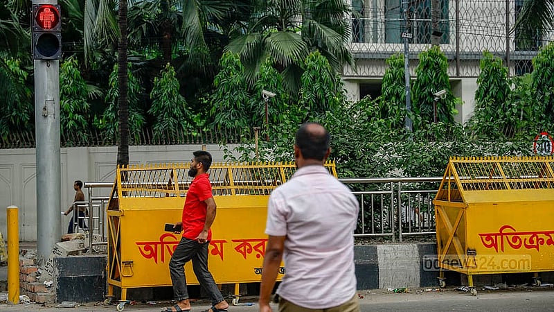 There are designated places for pedestrians to cross the road and red and green traffic signals to tell them when to go. But no one follows the signal. Photo: Mahmud Zaman Ovi