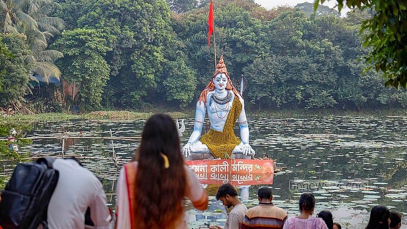 An idol of Lord Shiva is placed in the pond outside the Ramna Kali Temple in Dhaka during Durga Puja. Photo: Mahmud Zaman Ovi