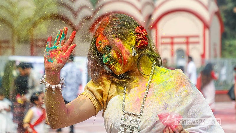 A young woman covered in powdered colours at Dhakeshwari Temple on Tuesday, Mar 3, 2026. Photo: Abdullah Al Momin