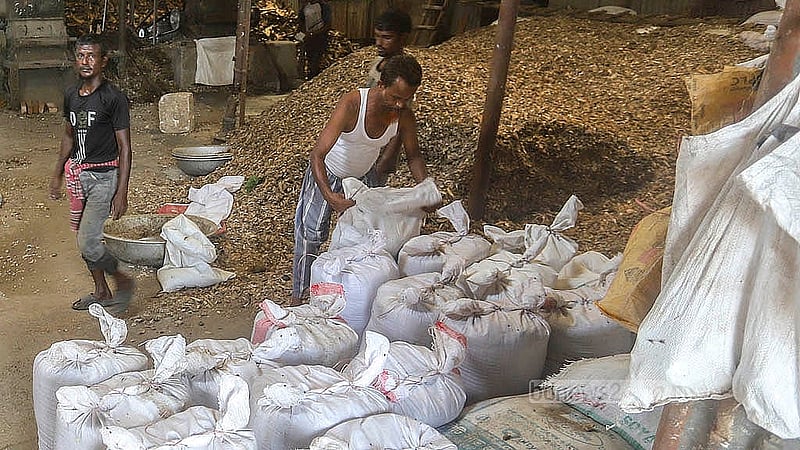 Workers are filling bags with the crushed bones. Photo: Abdullah al Momin