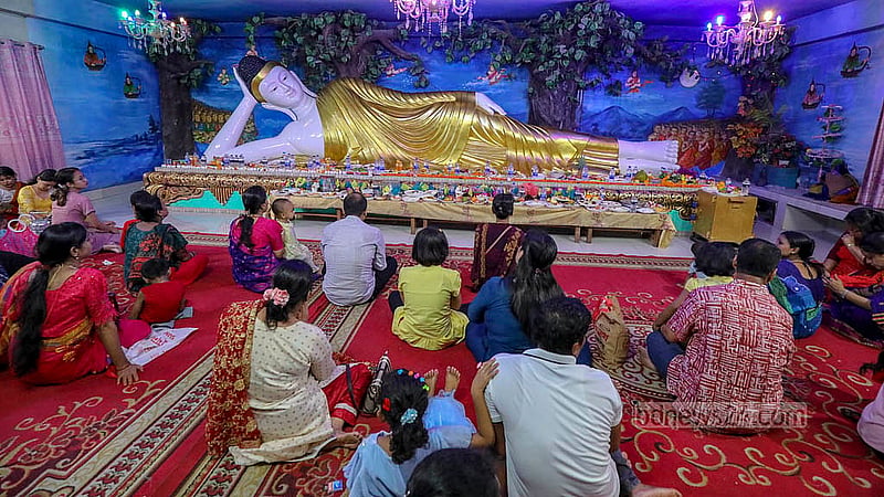 Devotees pray in front of a statue of Lord Buddha in Dhaka on their largest festival Buddha Purnima on Wednesday, May 22, 2024. Photo: Mahmud Zaman Ovi