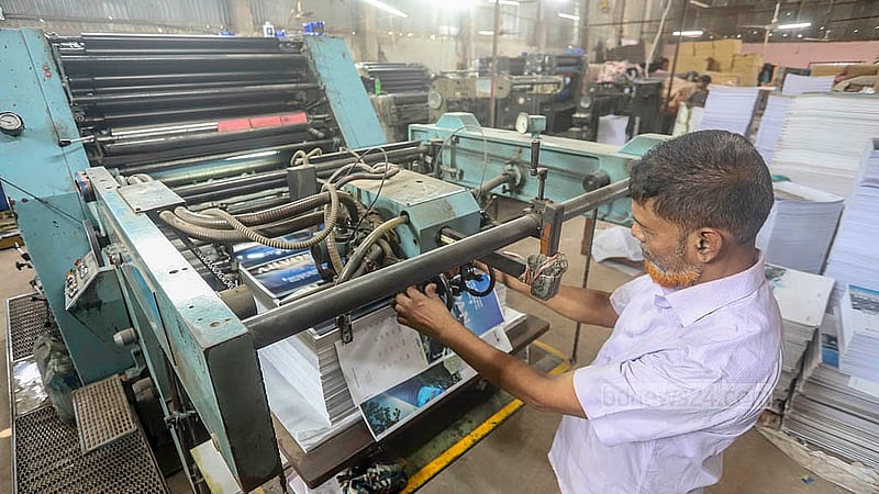 Printing of calendars for the New Year 2025 is under way at a house in Dhaka's Matuai. Photo: Abdullah al Momin