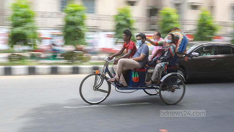 Many battery-powered rickshaws have their driver's seat extended to accommodate more passengers. Hence, one passenger can sit in the front, with two more in the back. Photo: Abdullah Al Momin