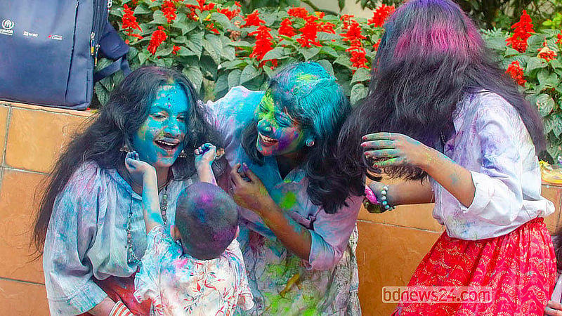 Young people, covered in powdered colours, dance during the Doljatra at Dhakeshwari Temple on Tuesday, Mar 3, 2026. Photo: Abdullah Al Momin