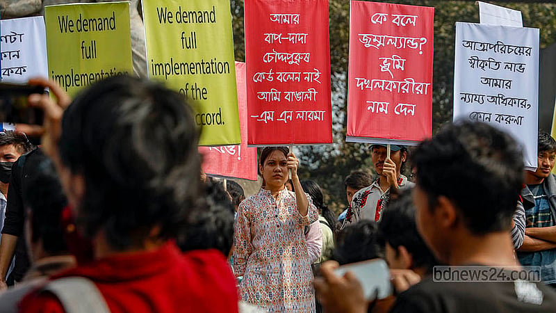 Students from ethnic minority groups gathered at the foot of the Raju Memorial Sculpture at Dhaka University on Wednesday, Jan 15, 2025, holding banners to protest the removal of images featuring the word “adivasi” – a collective term for a number of ethnic minority groups in Bangladesh – from textbooks. Photo: Mahmud Zaman Ovi