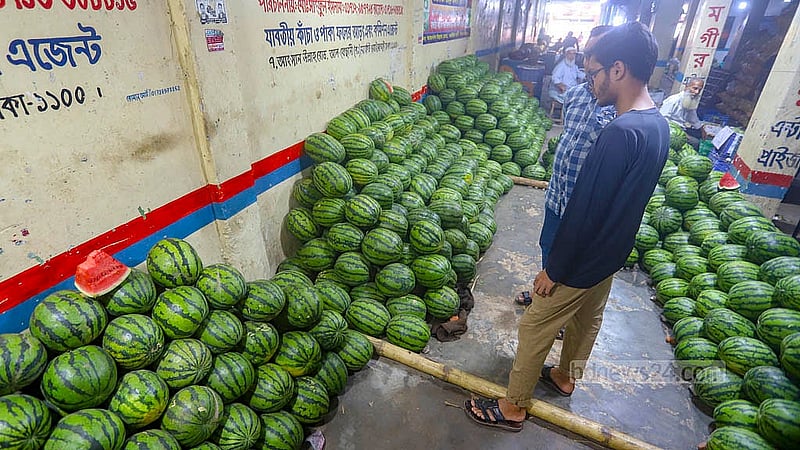 Inside a warehouse at Badamtoli Ghat, workers stack watermelons shipped from Gowainghat in Sylhet. These early arrivals are in high demand as the season’s first fruits reach the market. Photo: Abdullah Al Momin