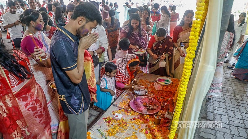 Sanatan devotees apply small amounts of powdered colours to an idol at Dhakeshwari Temple on Tuesday, Mar 3, 2026. Photo: Abdullah Al Momin