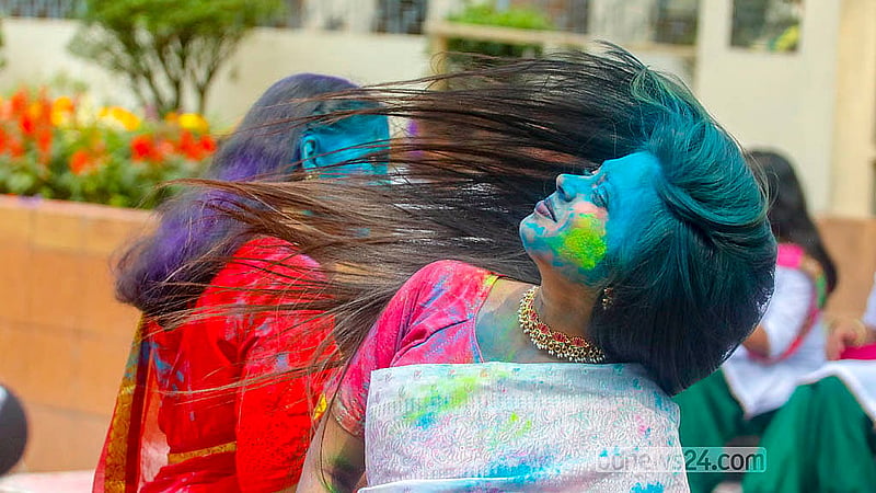 A young woman covered in powdered colours at Dhakeshwari Temple on Tuesday, Mar 3, 2026. Photo: Abdullah Al Momin