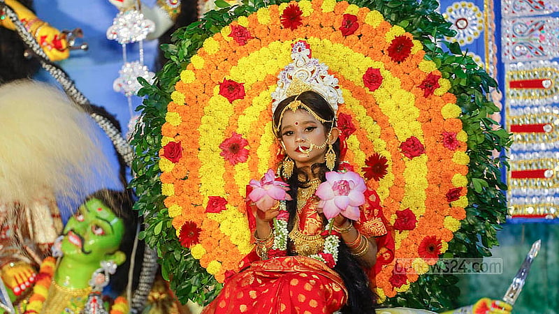 A child is seen worshipped in the form of a Kumari sitting on the throne of the goddess at the Ramakrishna Mission in Dhaka on Tuesday, the eighth day of Durga Puja. Photo: Abdullah Al Momin