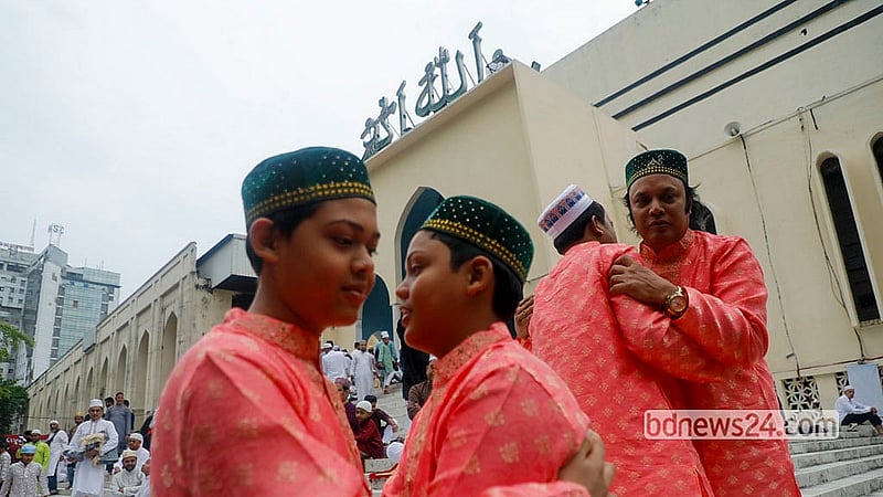 Devotees embrace after the Eid-ul-Fitr prayers at Baitul Mukarram National Mosque on Saturday morning. Photo: Abdullah Al Momin