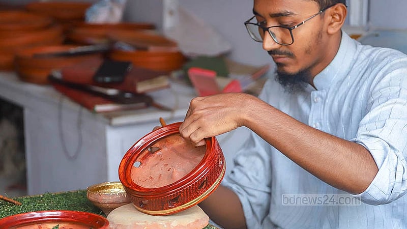 Unpainted clay products are brought to Farashganj in Old Dhaka's Sutrapur. A worker paints them at a local shop. Photo: Abdullah Al Momin