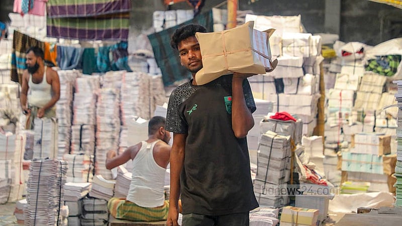 Workers complete the final stages of book preparation at Bright Printing Press in the Matuail area in Dhaka’s Jatrabari, where they were busy on Saturday, Nov 1, 2025. Photo: Abdullah al Momin