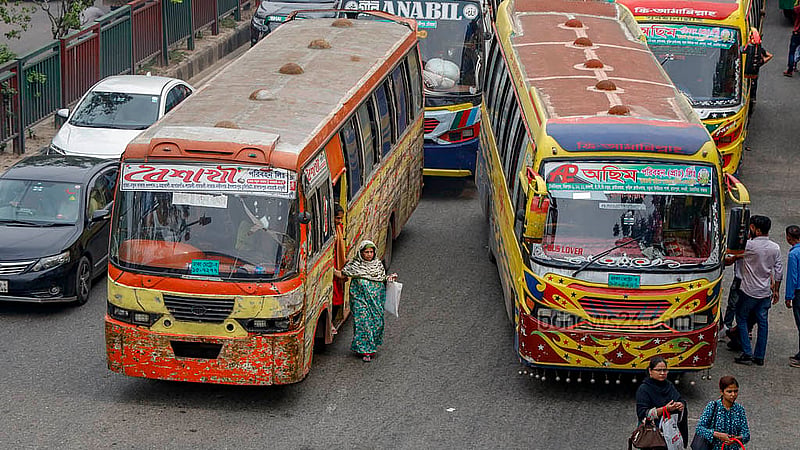 A passenger is forced to disembark from a moving bus in the middle of the street in Dhaka’s Notun Bazar although the stoppage is just a few yards away as the driver does not want to let other buses overtake him. Photo: Mahmud Zaman Ovi