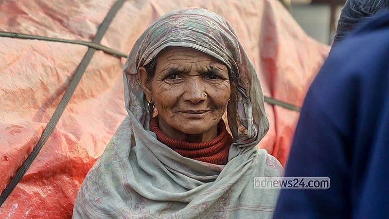 Josna Begum, 60, sits waiting for work at the “day labour market” at the Hemayetpur bus terminal area in Savar. Photo: Abdullah Al Momin