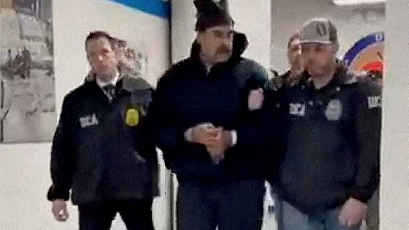A still image from video posted by the White House's Rapid Response 47 account on X.com, which originated from the @PaulDMauro account, shows Venezuela's President Nicolas Maduro being walked in custody down a hallway at the offices of the US Drug Enforcement Administration (DEA) in New York City, US, Jan 3, 2026. @RapidResponse47/Handout via REUTERS 