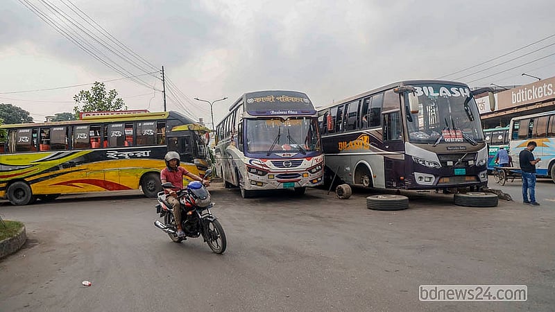 Buses occupy two out of the three lanes on the road in front of the Mohakhali Bus Terminal, forcing all traffic into a single lane.