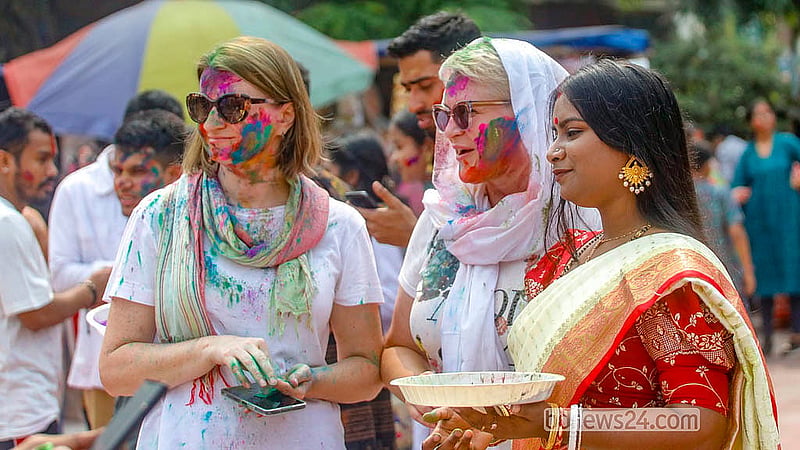 Foreigners also participate in the Doljatra at Dhakeshwari Temple on Tuesday, Mar 3, 2026.  Photo: Abdullah Al Momin