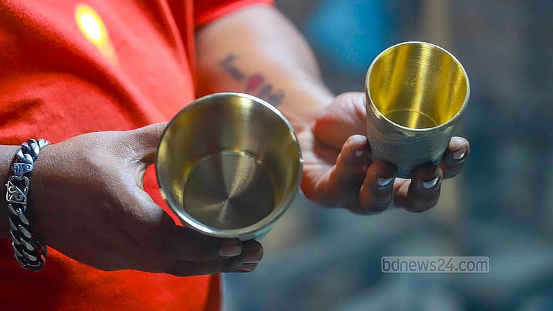 A man holds a brass mug at the Islamia Metal Factory in in Jhaulahati in Dhaka’s Kamrangirchar. A kilogram of brass products is sold for Tk 4,000. Photos: Abdullah Al Momin