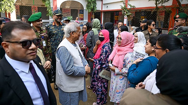 After voting at the Gulshan Model School and College centre, Muhammad Yunus speaks with voters outside the polling station. Photo: PID