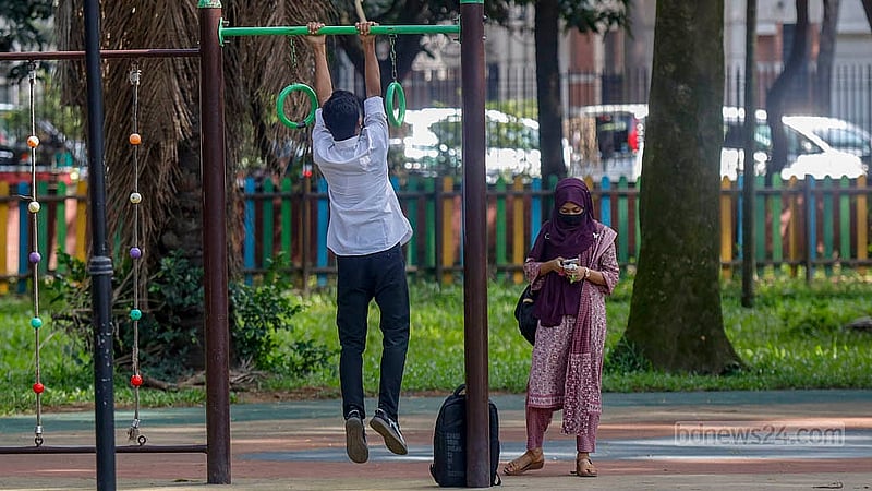 Adults use playground equipment meant for children in the designated play area at Ramna Park in Dhaka. Photo: Mahmud Zaman Ovi