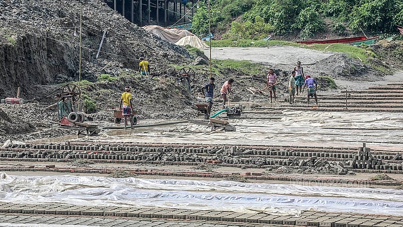 Workers at a brick kiln damaged by rain in Jajira, South Keraniganj, Dhaka. Photo: Abdullah Al Momin