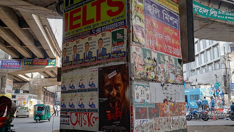 In the eight months since students painted vibrant graffiti to celebrate the July Uprising, many of the images have been covered up by posters and banners advertising coaching centres and shopping centres. Photo: Mahmud Zaman Ovi